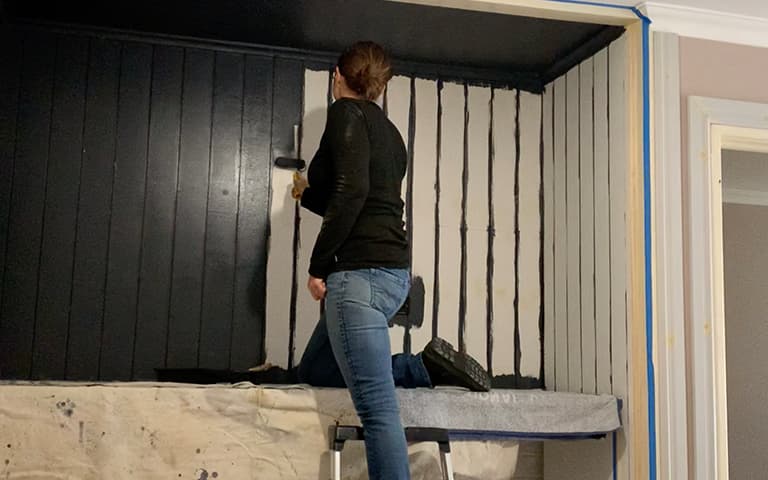 Laundry wall rolling paint onto wall